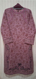 A mauve-colored long-sleeve kurta with an allover floral jacquard pattern, featuring embroidered details along the neckline, cuffs, and hem.